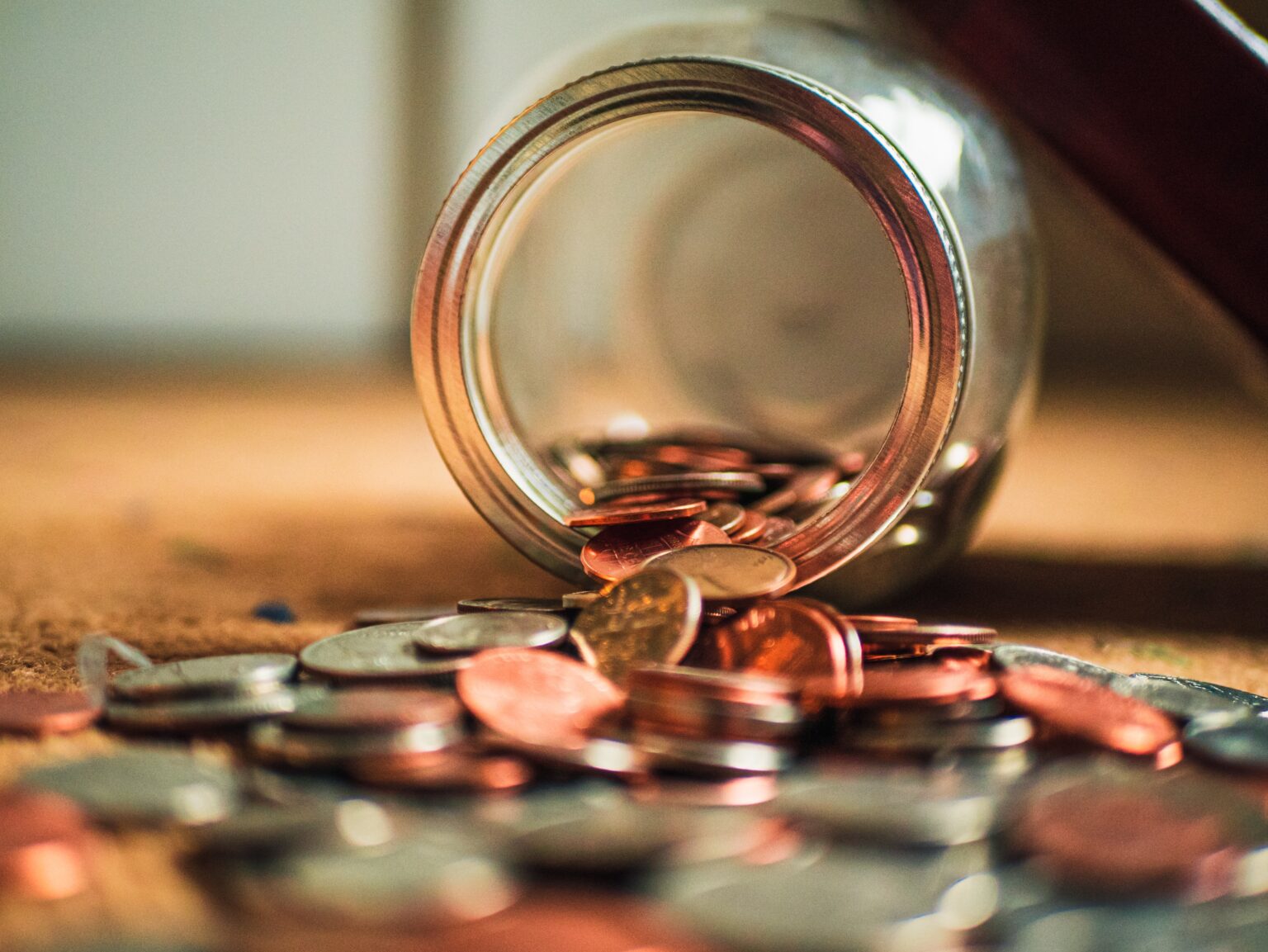 Spilled jar of change to illustrate money