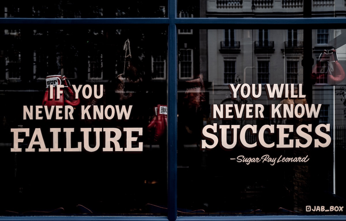 Motivational sign in the window of a boxing gym.