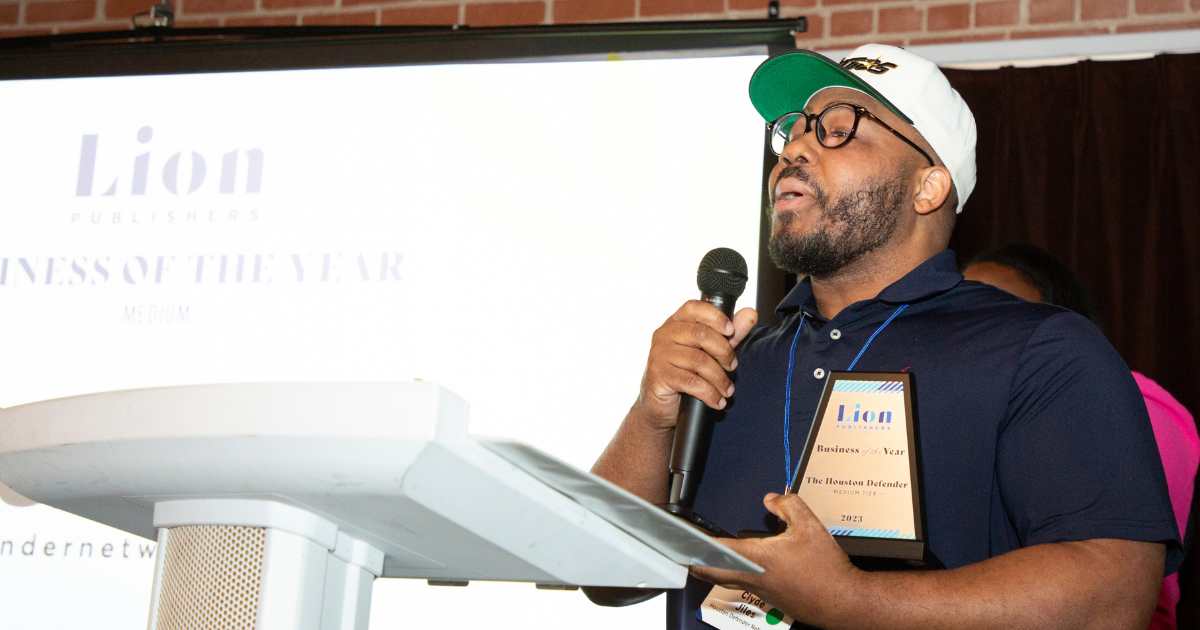 Award winner stands at podium on stage