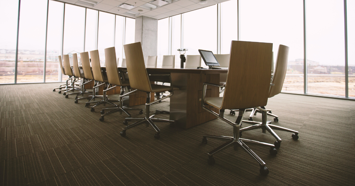 Executive board room table surrounded by windows